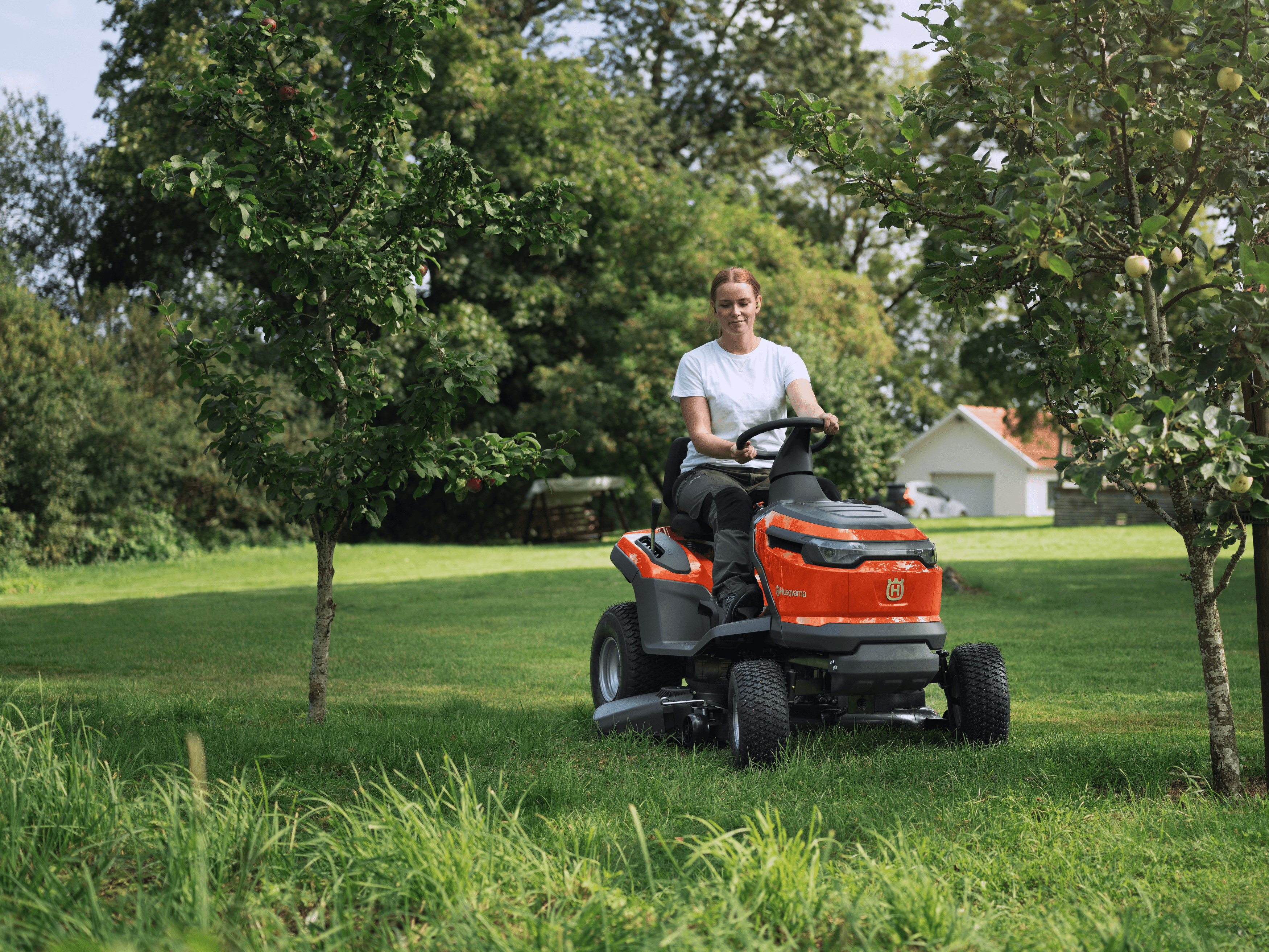 man holding chainsaw whilst cutting tree